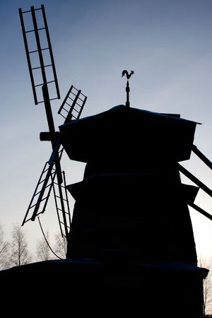 photo of the windmill silhouette with blue sky in background stock