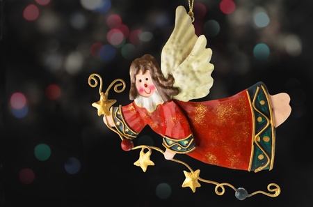 Tinplate angel christmas tree ornaments with a background of blurry lights Stock Photo