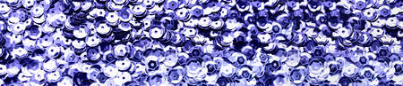 Texture of violet shiny sequins. fashionable bright fabric with sequins. banner. color 2022. Stock Photo