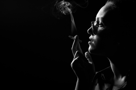 黒い背景 プロフィールビュー モノクロでタバコを吸う深刻な女性 の写真素材 画像素材 Image