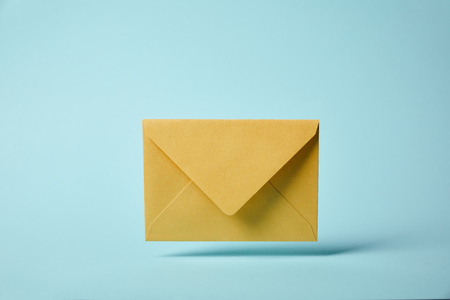 Yellow and colorful envelope on blue background with copy space Stock Photo