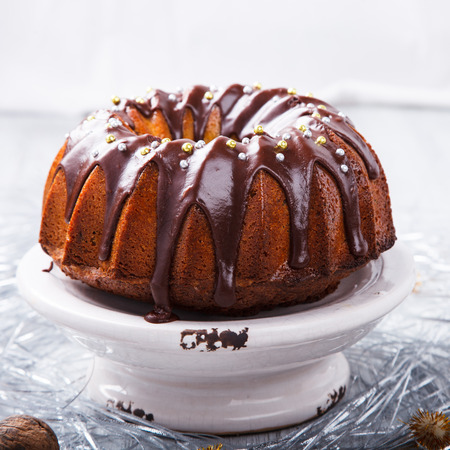 stock photo traditional christmas fruit cake in chocolate coating with nuts decor on a christmas decoration backgroundselective focus - Christmas Fruit Cake Decoration stock photo traditional christmas fruit cake in chocolate coating with nuts decor on a christmas decoration backgroundselective focus - Christmas Fruit Cake Decoration