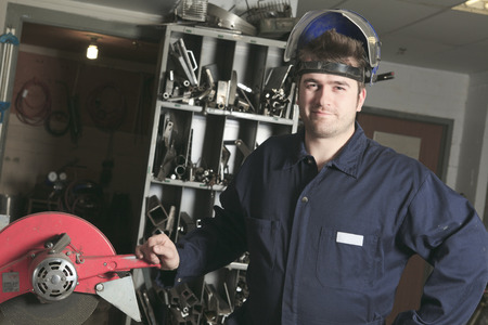 Worker with protective mask welding metal