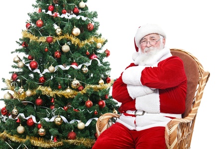 santa claus sitting in rocking chair with crossed arms and relax decorated christmas tree - Santa Decorated Christmas Tree santa claus sitting in rocking chair with crossed arms and relax decorated christmas tree - Santa Decorated Christmas Tree
