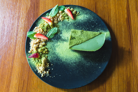 matcha green tea ice cream cake with strawberry and cookie crumble