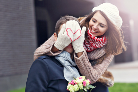 Picture showing young couple with flowers dating in the city