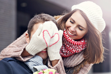 Picture showing young couple with flowers dating in the city