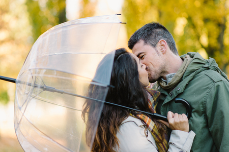 lovely young couple kissing in autumn at the park romantic man