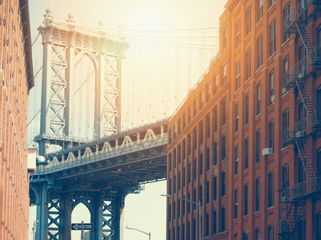 Manhattan bridge and a brick buildings in brooklyn street new york usa