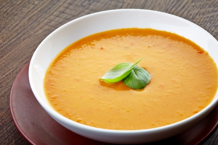 a carrot: squash soup with basil leaf in a bowl Kho ảnh