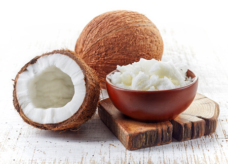 coconut: bát dầu dừa và tươi dừa trên bàn gỗ trắng