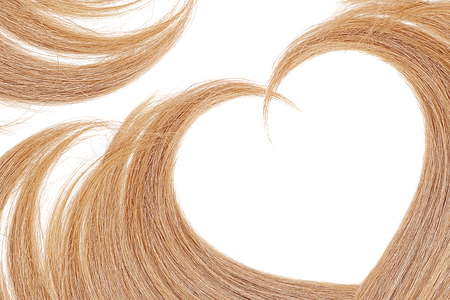 Blond hair in shape of heart, isolated on white background Banco de Imagens