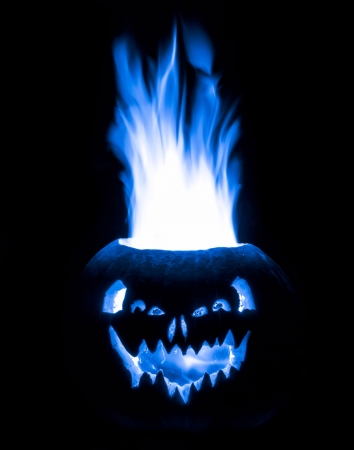 a halloween jack o lantern pumpkin that is emitting electric blue fire isolated on