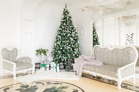 Luxury apartment decorated for christmas. xmas tree with presents underneath in living room