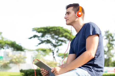 Aspirated man using tablet to listen to music