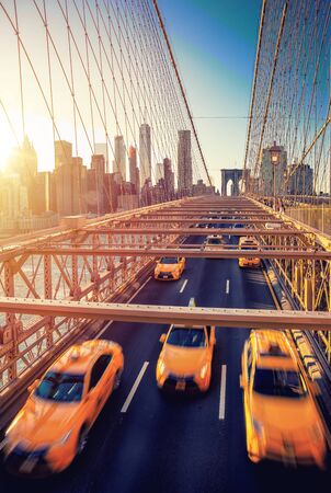 Cubs speeding at sunset on brooklyn bridge manhattan one of the most iconic bridges in the world new york city