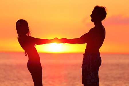 silhouette couple holding hands at beach stock photo picture and royalty free image image 44395843
