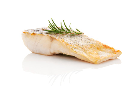 Luxurious seafood dinner. Perch fish fillet isolated on white background with fresh green herbs. Healthy eating. Stockfoto