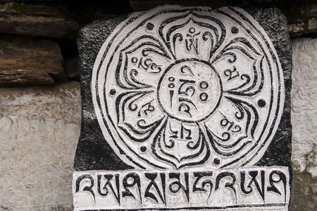 Chaurikharka, nepal - circa october 2013: mani stones with the inscription mantra is one of the elements of the buddhist religion circa october 2013 in chaurikharka. Stock Photo