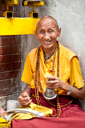 Kathmandu, nepal - may 18: unidentified buddhist monk is praying in bouddanath stupa on may 18, 2013 in kathmandu, nepal.