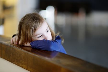 sad lonely: Thoughtful little girl portrait indoors
