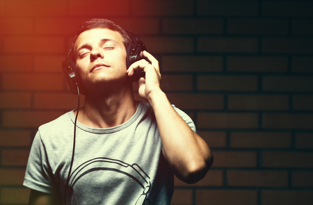Portrait of a handsome young man listening to music