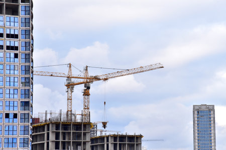 View of a large construction site tower cranes in action crane and builders on formworks of the building new residential skyscraper tall house renovation project building construction