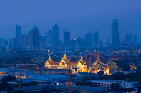 The Golden Grand Palace of Bangkok with Bangkok skyscraper view of cityscape at sunrise time. The most favorite landmark of travel destination of Bangkok. Best of amazing beautiful scene of Thailand