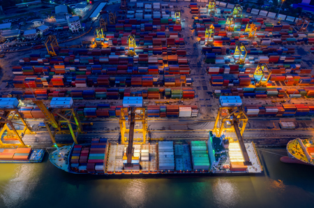containers yard in port congestion with ship vessels are loading