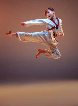 Karate Jump Kick Kid 450x333 Karate Kick Stock Photos and Images - 123RF