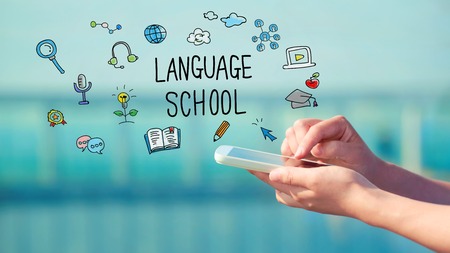 Language School concept with person holding a smartphone