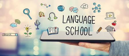 Language School concept with man holding a tablet computer