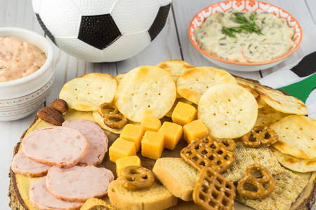 close up of party table with variety of snacks and dips for soccer