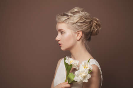 Gentle Young Beauty. Young Blonde Woman With White Flowers On Brown Banner Background