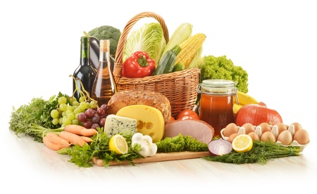 Composition with groceries in wicker basket on kitchen table - 15375755