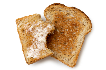 half eaten buttered slice of whole wheat toast and whole dry stock