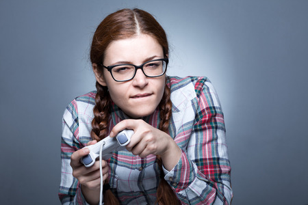 85002541-nerd-woman-with-braid-playing-videogames-with-a-joypad.jpg