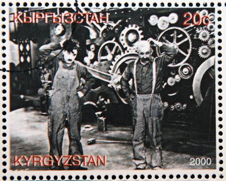 KYRGYZSTAN - CIRCA 2000: A stamp printed in Kyrgyzstan shows scene from the movie Modern Times by Charles Chaplin, circa 2000 Editorial
