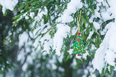 handmade wooden ornament of fully decorated christmas tree is hanging on snowy spruce twig stock photo - Fully Decorated Christmas Tree handmade wooden ornament of fully decorated christmas tree is hanging on snowy spruce twig stock photo - Fully Decorated Christmas Tree