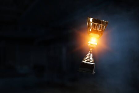 Golden cup on dark . mixed media