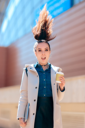 Funny girl with hot drink coffee cup for extra morning energy Banco de Imagens