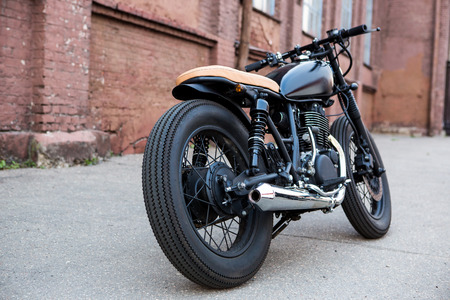 black vintage custom motorbike motorcycle caferacer in front stock