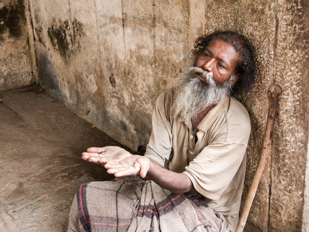 MELKOTE, INDIA - MAY 9th - An old Indian beggar waits for alms on a street corner on May 9th 2008 at Melkote, India. Stock Photo - 65902027