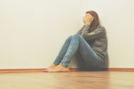 sad lonely: Sad girl hiding in corner at home