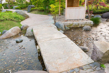 stone path in a japanese garden stone bridge across a tranquil pond stock - Japanese Garden Stone Bridge stone path in a japanese garden stone bridge across a tranquil pond stock - Japanese Garden Stone Bridge