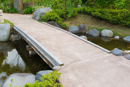 stone path in a japanese garden stone bridge across a tranquil pond photo - Japanese Garden Stone Bridge stone path in a japanese garden stone bridge across a tranquil pond photo - Japanese Garden Stone Bridge