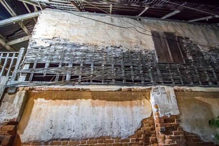 Old house along walking street(Chai Khong Road) in Chiang Khan,Loei,Thailand.Close-up the wall.