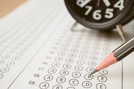 answer sheet alarm clock and pencil for education concept stock