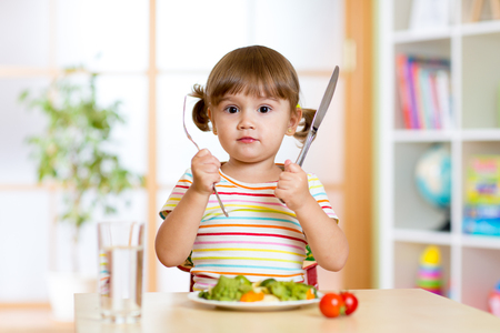 child little girl with fork and knife ready to eat - 46065125