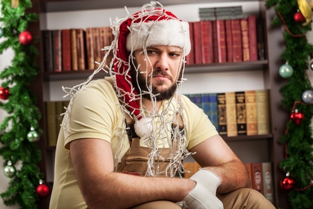 young man trying to fix christmas tree lights stock photo picture fixes christmas tree lights